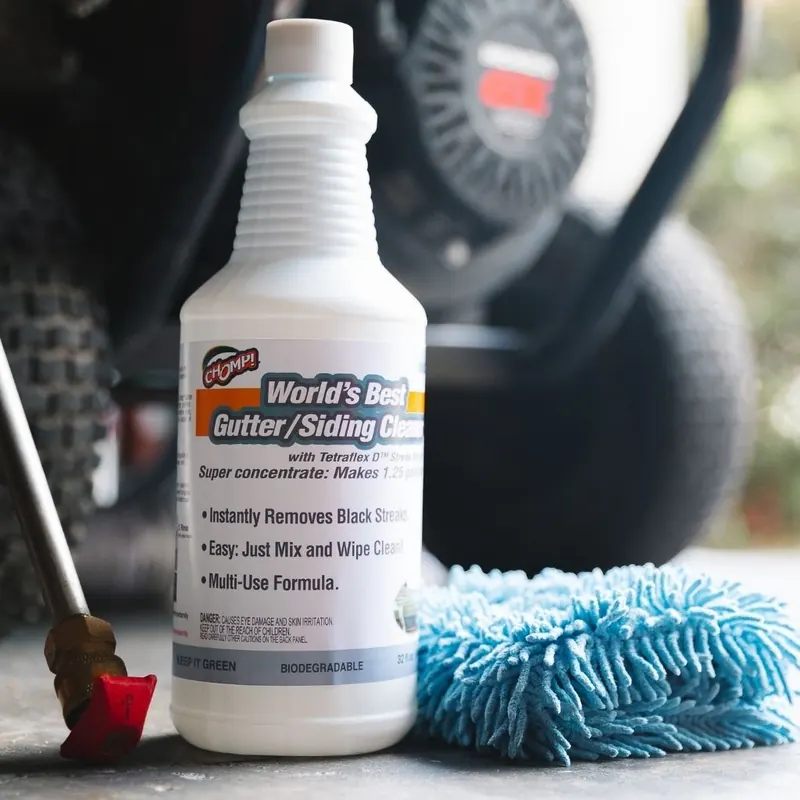 Bottle of World's Best Gutter/Siding Cleaner beside a blue microfiber wash mitt